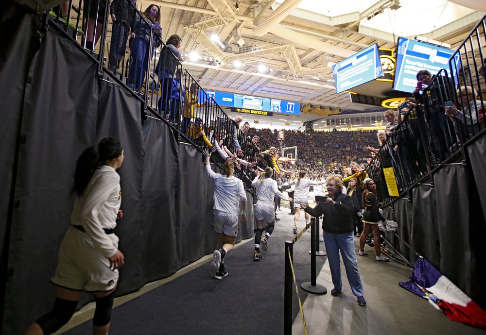 The Iowa Hawkeyes run onto the court before their second round game in the 2019 NCAA Women's Basketball Tournament at Carver Hawkeye Arena in Iowa City on Sunday, Mar. 24, 2019. (Stephen Mally for hawkeyesports.com)