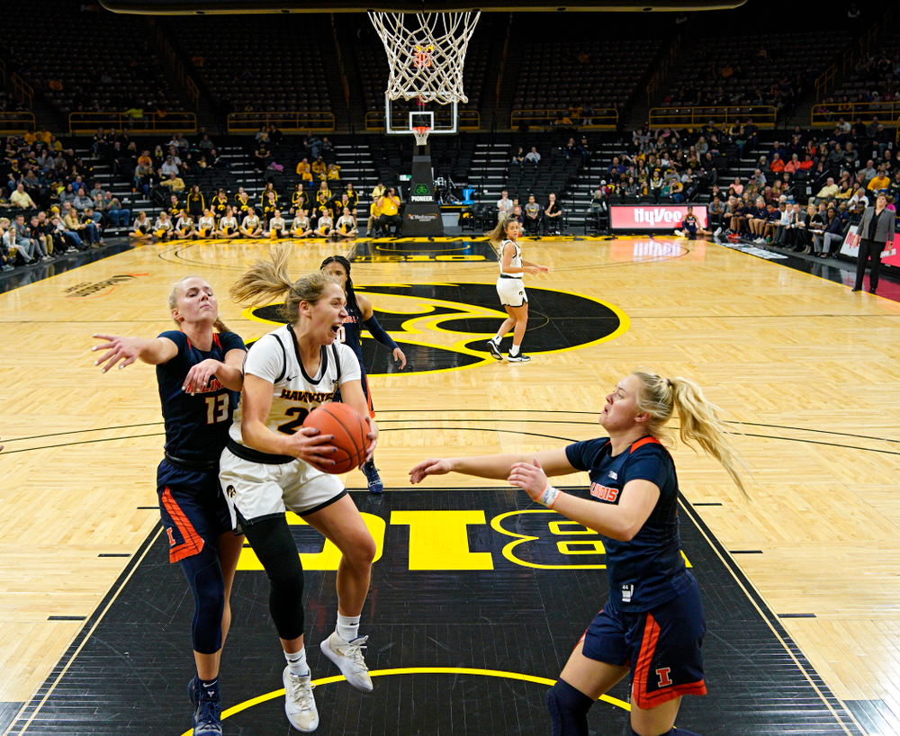 Iowa Hawkeyes guard Kathleen Doyle (22) pulls in a rebound during the third quarter of their game at Carver-Hawkeye Arena in Iowa City on Tuesday, December 31, 2019. (Stephen Mally/hawkeyesports.com)