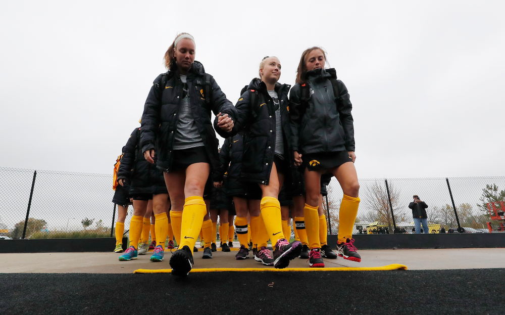 The Iowa Hawkeyes seniors cross the line Sunday, October 14, 2018 before their game against Maryland. (Brian Ray/hawkeyesports.com)