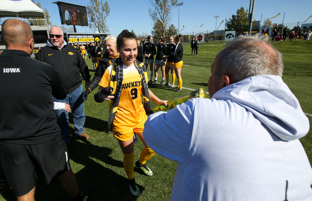 Iowa Hawkeyes head coach Dave DiIanni presents Iowa Hawkeyes defender Karsen Rauch (9) with a framed photo during Senior Day ceremonies before a game against Northwestern at the Iowa Soccer Complex on October 21, 2018. (Tork Mason/hawkeyesports.com)