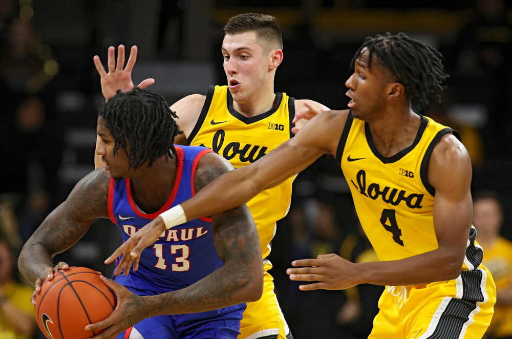 Iowa Hawkeyes guard CJ Fredrick (5) and Iowa Hawkeyes guard Bakari Evelyn (4) defend during the second half of their game at Carver-Hawkeye Arena in Iowa City on Monday, Nov 11, 2019. (Stephen Mally/hawkeyesports.com)