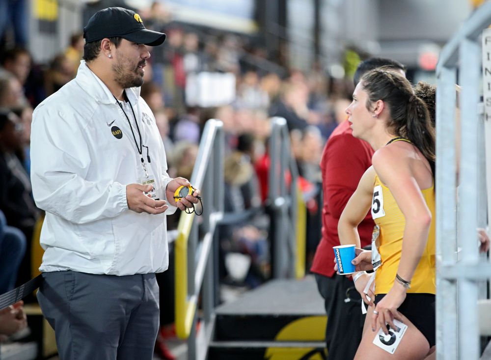 Iowa assistant coach/recruiting coordinator Jason Wakenight (from left) talks with Mallory King and Tia Saunders after they ran the women’s 400 meter dash event during the Larry Wieczorek Invitational at the Recreation Building in Iowa City on Saturday, January 18, 2020. (Stephen Mally/hawkeyesports.com)