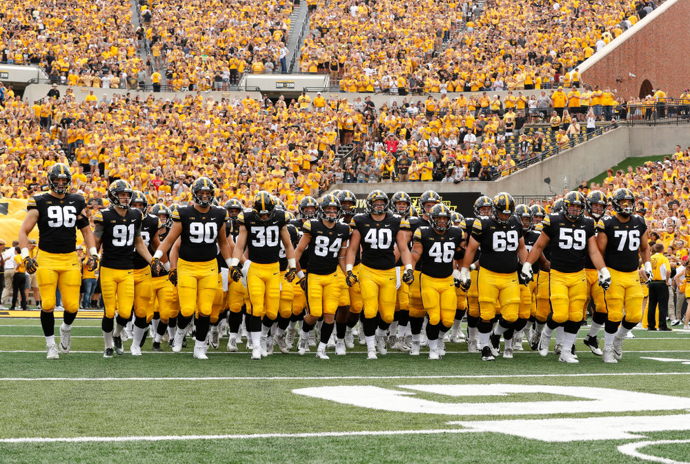 The Iowa Hawkeyes swarm onto the field against the Northern Illinois Huskies Saturday, September 1, 2018 at Kinnick Stadium. (Brian Ray/hawkeyesports.com)