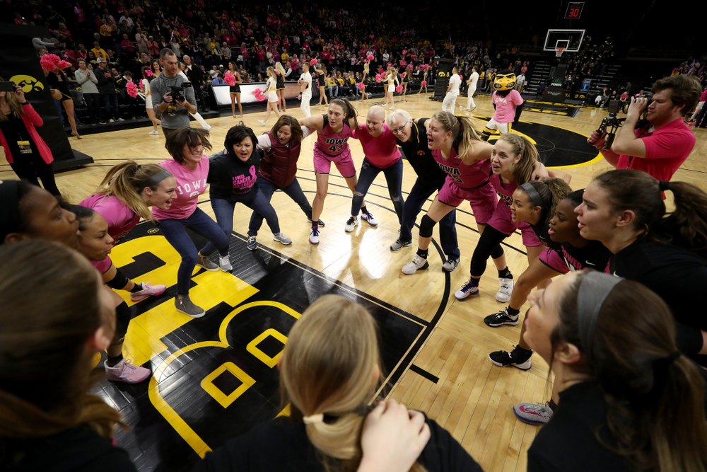 The Iowa Hawkeyes gather with women affected by breast cancer before their game against the Wisconsin Badgers Sunday, February 16, 2020 at Carver-Hawkeye Arena. (Brian Ray/hawkeyesports.com)