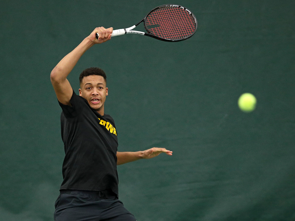 Iowa’s Oliver Okonkwo returns a shot during their match at the Hawkeye Tennis and Recreation Complex in Iowa City on Thursday, January 16, 2020. (Stephen Mally/hawkeyesports.com)