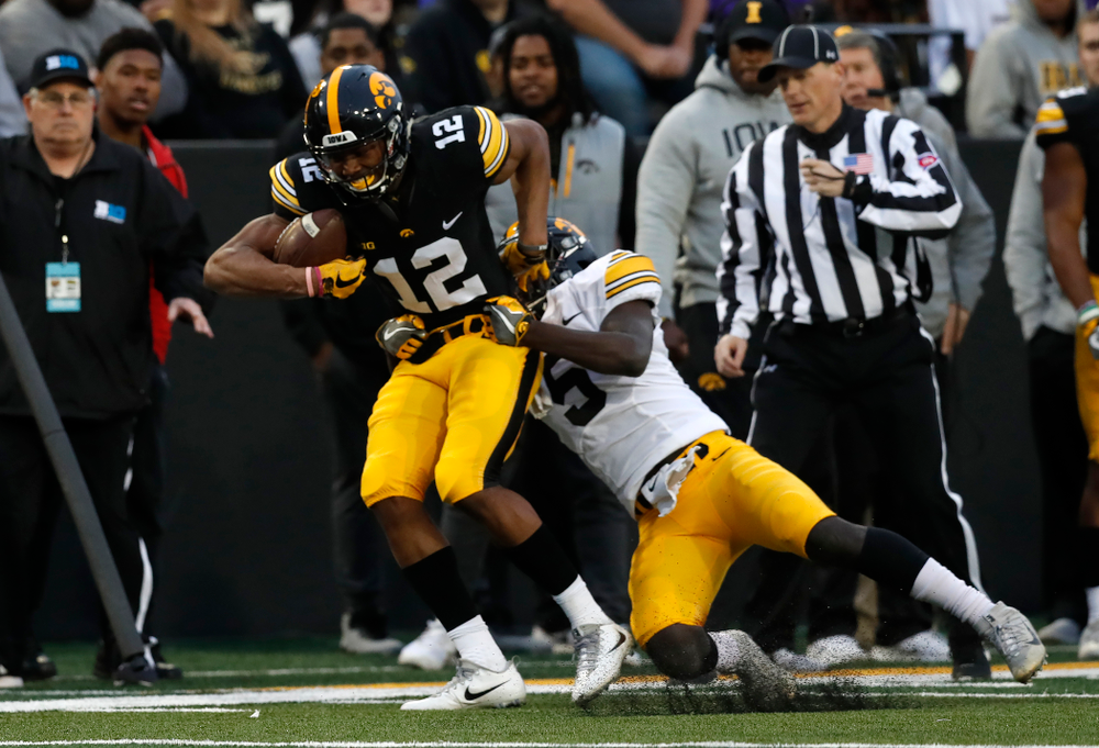 Iowa Hawkeyes wide receiver Brandon Smith (12) and defensive back Manny Rugamba (5) during the final spring practice Friday, April 20, 2018 at Kinnick Stadium. (Brian Ray/hawkeyesports.com)