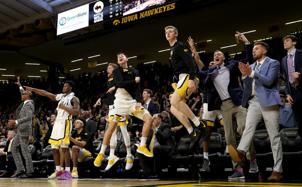 Iowa Hawkeyes guard Austin Ash (13), forward Michael Baer (0), forward Jack Nunge (2), and Jordan Bohannon celebrate on the bench against the Michigan Wolverines Friday, January 17, 2020 at Carver-Hawkeye Arena. (Brian Ray/hawkeyesports.com)