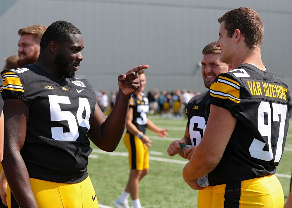 Iowa Hawkeyes defensive tackle Daviyon Nixon (54) pretends to interview defensive lineman Zach VanValkenburg (97) during Iowa Football Media Day at the Hansen Football Performance Center in Iowa City on Friday, Aug 9, 2019. (Stephen Mally/hawkeyesports.com)