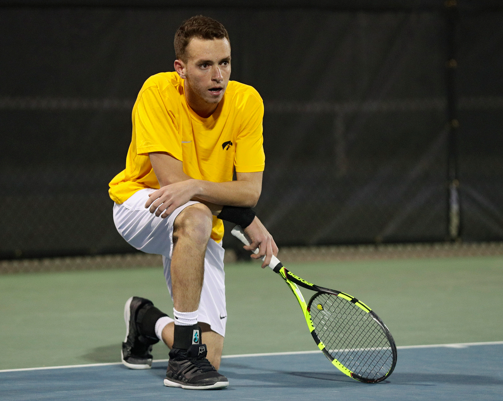 Iowa's Kareem Allaf drops to a knee after winning his match again Michigan State at the Hawkeye Tennis and Recreation Complex in Iowa City on Friday, Apr. 19, 2019. (Stephen Mally/hawkeyesports.com)
