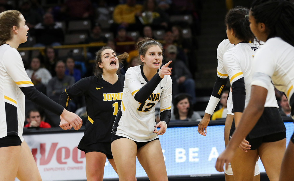 Iowa Hawkeyes defensive specialist Molly Kelly (1) and Iowa Hawkeyes defensive specialist Emily Bushman (12) celebrate after winning a point during a match against Maryland at Carver-Hawkeye Arena on November 23, 2018. (Tork Mason/hawkeyesports.com)