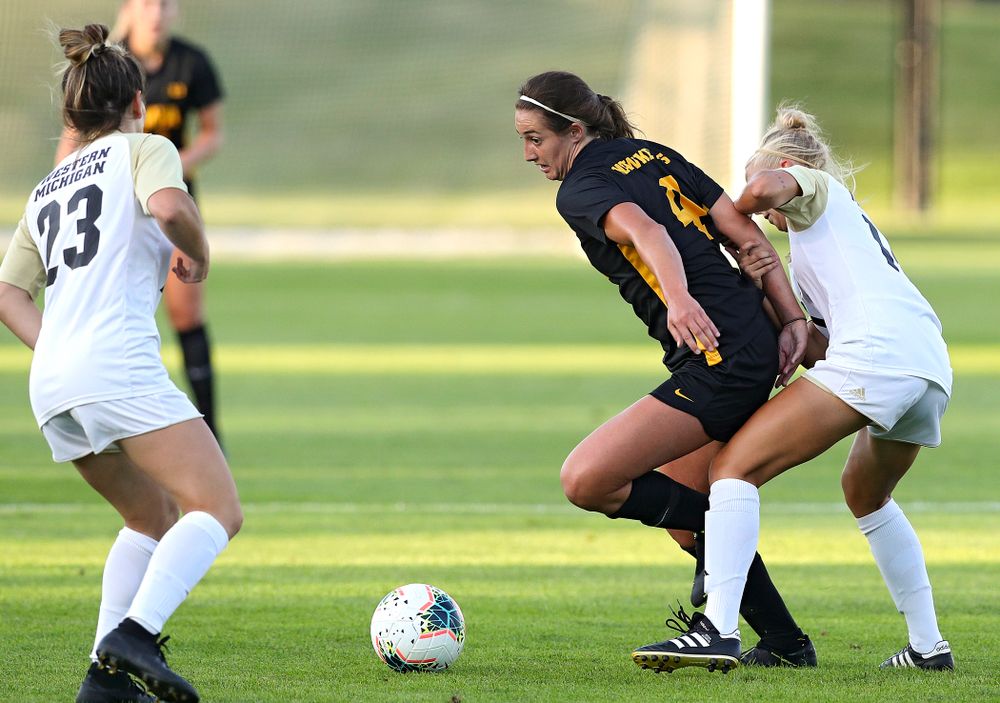 Iowa forward Kaleigh Haus (4) tries to move between two defenders during the first half of their match against Western Michigan at the Iowa Soccer Complex in Iowa City on Thursday, Aug 22, 2019. (Stephen Mally/hawkeyesports.com)