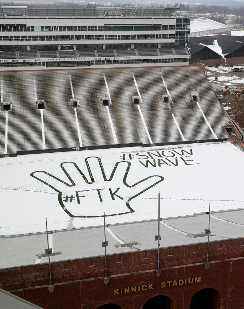 Members of the Iowa Athletics Turf Management staff create the #SnowWave for kids in the Stead Family Children's Hospital Thursday, February
