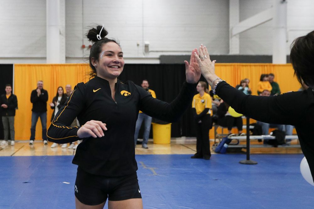 Carina Tolan high fives assistant coach Jennifer Green before the Iowa women’s gymnastics Black and Gold Intraquad Meet on Saturday, December 7, 2019 at the UI Field House. (Lily Smith/hawkeyesports.com)