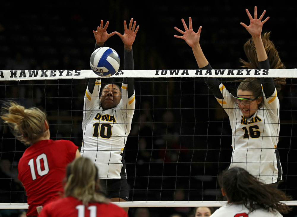 Iowa’s Griere Hughes (10) blocks a shot as Grace Tubbs (16) looks on during the third set of their match against Nebraska at Carver-Hawkeye Arena in Iowa City on Saturday, Nov 9, 2019. (Stephen Mally/hawkeyesports.com)