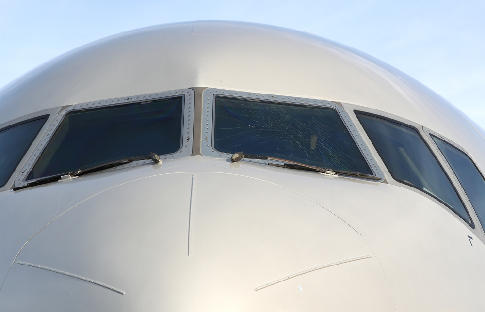 The outer layer of the front windscreen of the team plane is cracked Wednesday, December 26, 2018 as the Iowa Hawkeyes arrive in Tampa, Florida for the Outback Bowl. The flight crew scheduled to take the plane said the damage happened in flight and was due to fatigue from pressure changes in the air. (Brian Ray/hawkeyesports.com)