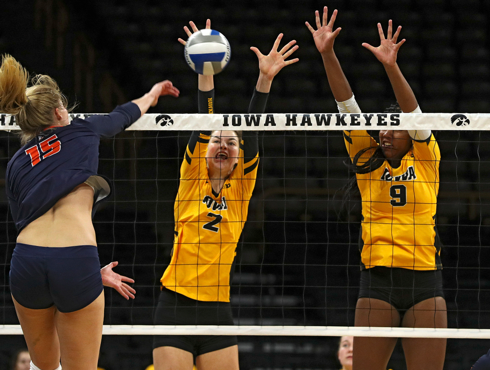 Iowa’s Courtney Buzzerio (2) blocks a shot as Amiya Jones (9) looks on during the third set of their match against Illinois at Carver-Hawkeye Arena in Iowa City on Wednesday, Nov 6, 2019. (Stephen Mally/hawkeyesports.com)