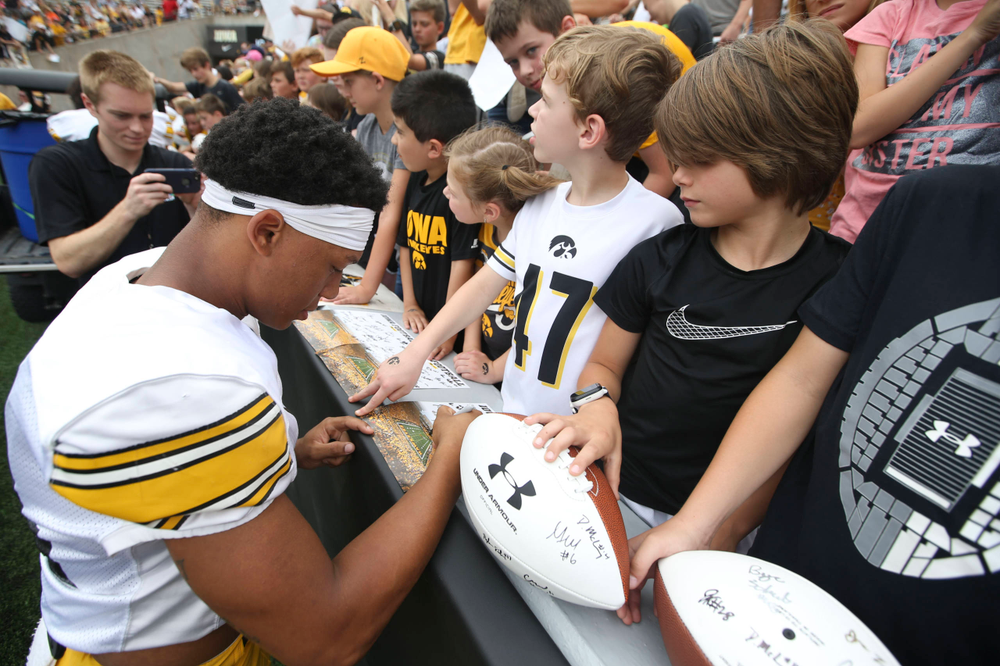 Iowa Hawkeyes defensive back Daraun McKinney (14) signs autographs during Kids Day at Kinnick Stadium on Saturday, August 10, 2019. (Lily Smith/hawkeyesports.com)