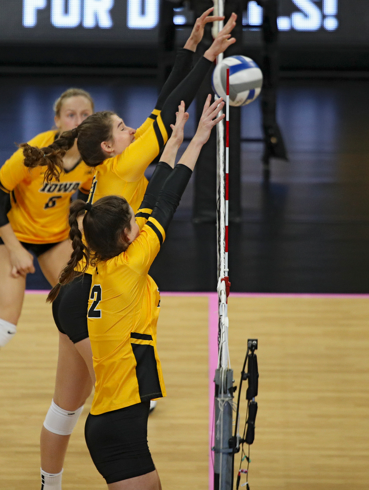Iowa’s Blythe Rients (11) blocks a shot as Courtney Buzzerio (2) looks on during their match at Carver-Hawkeye Arena in Iowa City on Sunday, Oct 20, 2019. (Stephen Mally/hawkeyesports.com)