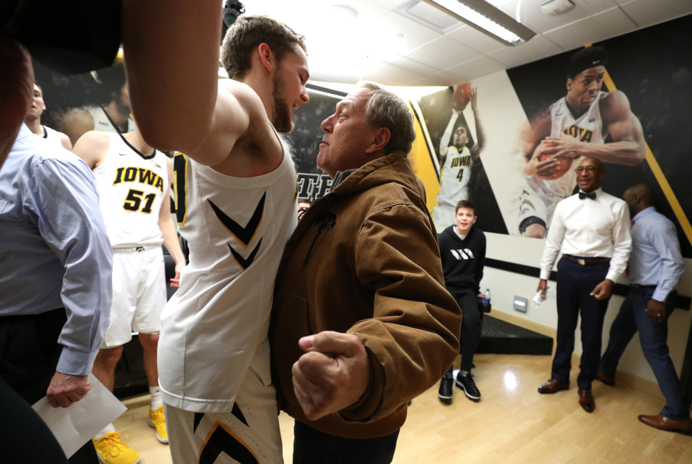 Iowa Hawkeyes forward Riley Till (20) chest bumps University of Iowa President Bruce Harreld following their victory over the Northwestern Wildcats Sunday, February 10, 2019 at Carver-Hawkeye Arena. (Brian Ray/hawkeyesports.com)