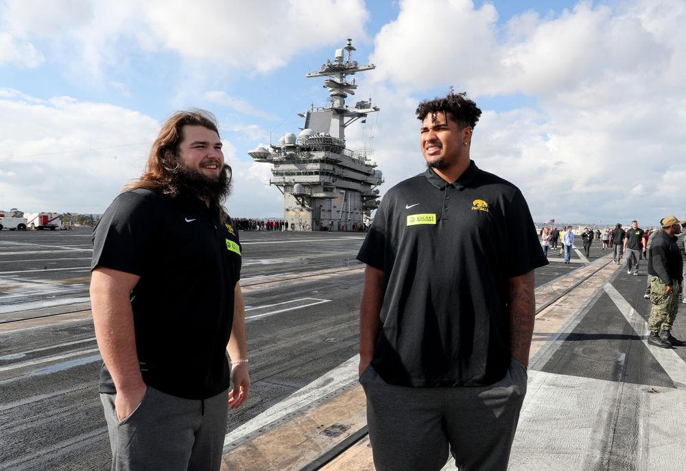 Iowa Hawkeyes offensive lineman Tristan Wirfs (74) and offensive lineman Kyler Schott (64) look around during a tour of the USS Theodore Roosevelt (CVN-71) Tuesday, December 24, 2019 at the Naval Base Coronado. (Brian Ray/hawkeyesports.com)