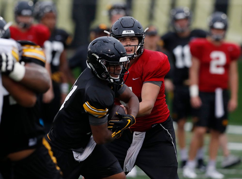 quarterback Nathan Stanley (4) and defensive back Josh Turner (4) during camp practice No. 15 Monday, August 20, 2018 at the Hansen Football Performance Center. (Brian Ray/hawkeyesports.com)