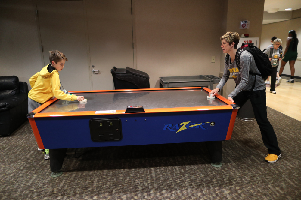 Associate head coach Jan Jensen plays air hockey with her son Jack following shoot around before their regional final against the Baylor Lady Bears in the 2019 NCAA Women's College Basketball Tournament Monday, April 1, 2019 at Greensboro Coliseum in Greensboro, NC.(Brian Ray/hawkeyesports.com)
