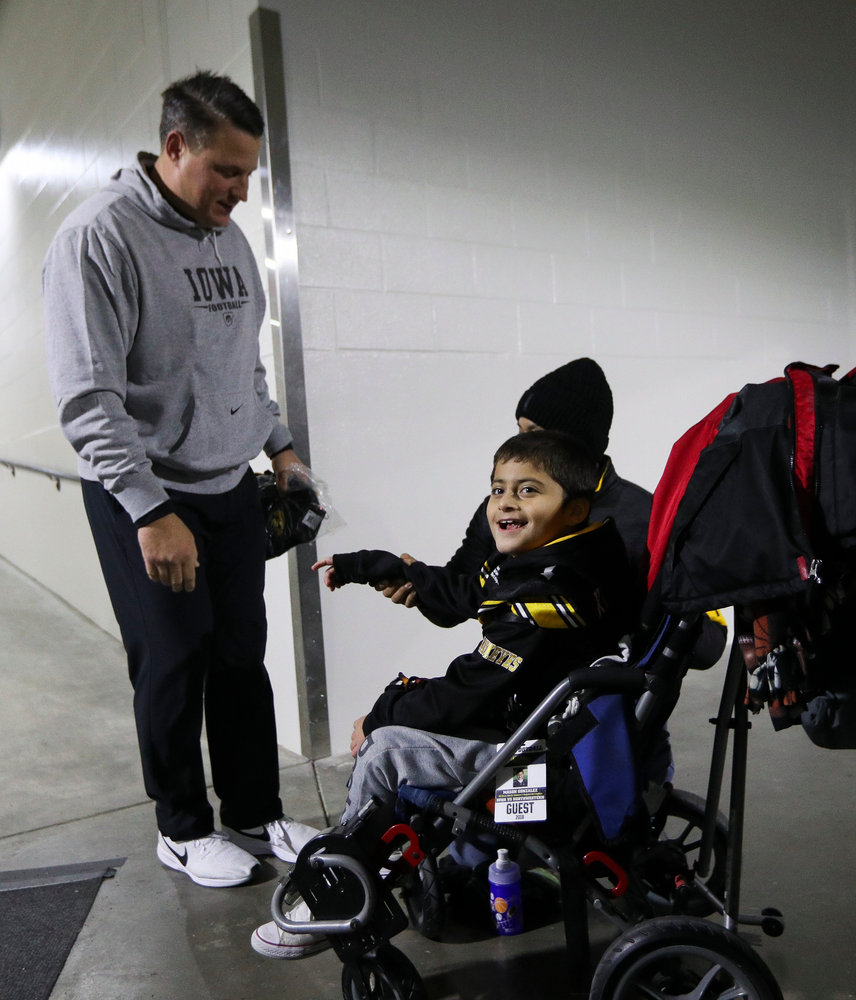 Iowa Hawkeyes offensive coordinator Brian Ferentz meets with Kid Captain Mason Gonzalez before a game against Northwestern at Kinnick Stadium on November 10, 2018. (Tork Mason/hawkeyesports.com)