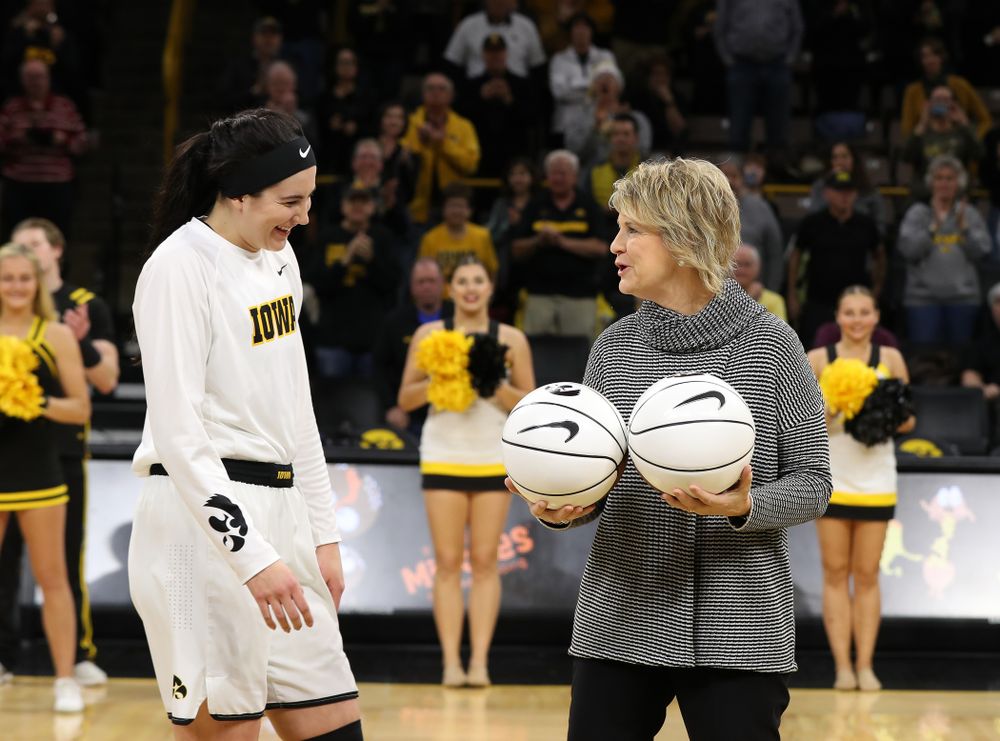Iowa Hawkeyes forward Megan Gustafson (10) receives a pair of commemorative basketballs from head coach Lisa Bluder for becoming the school's all time rebounds leader and scoring leader before their gam eagainst the Nebraska Cornhuskers Thursday, January 3, 2019 at Carver-Hawkeye Arena. (Brian Ray/hawkeyesports.com)