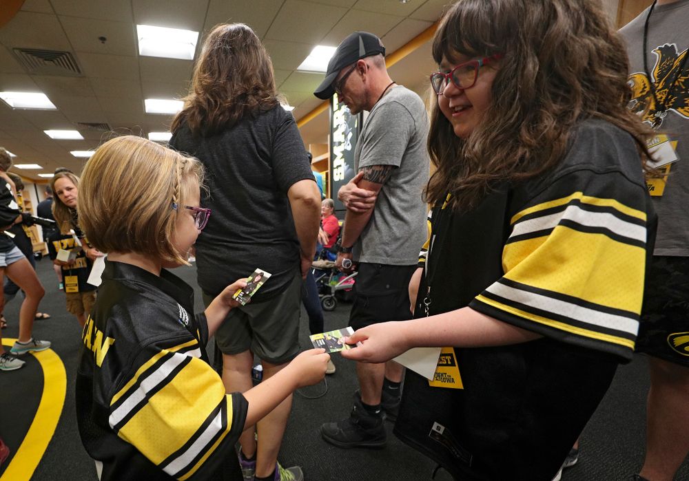Kid Captains Gabby Yoder (from left) and Lucy Roth exchange trading cards during Kids Day at Kinnick Stadium in Iowa City on Saturday, Aug 10, 2019. (Stephen Mally/hawkeyesports.com)