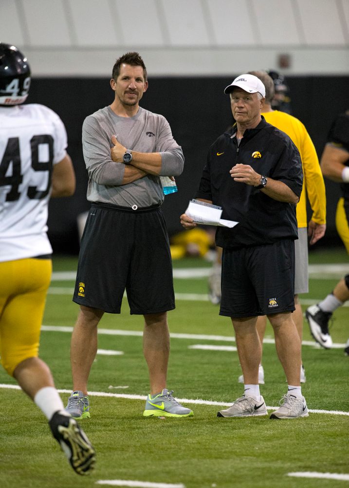 Former Hawkeye All-American tight end and 11 year NFL veteran Dallas Clark talks with defensive line coach Reese Morgan during the 19th practice of fall camp Wednesday, Aug. 19, 2015 in Iowa City. (Brian Ray/hawkeyesports.com)