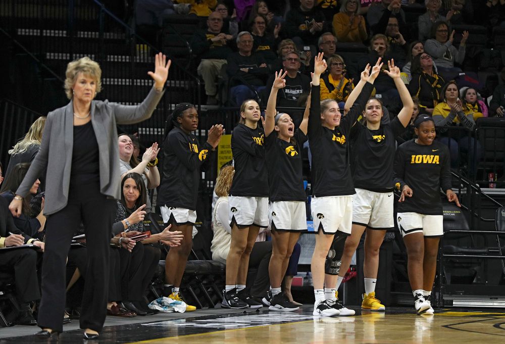 The Iowa bench celebrates after a 3-pointer during the first quarter of their game at Carver-Hawkeye Arena in Iowa City on Sunday, January 12, 2020. (Stephen Mally/hawkeyesports.com)