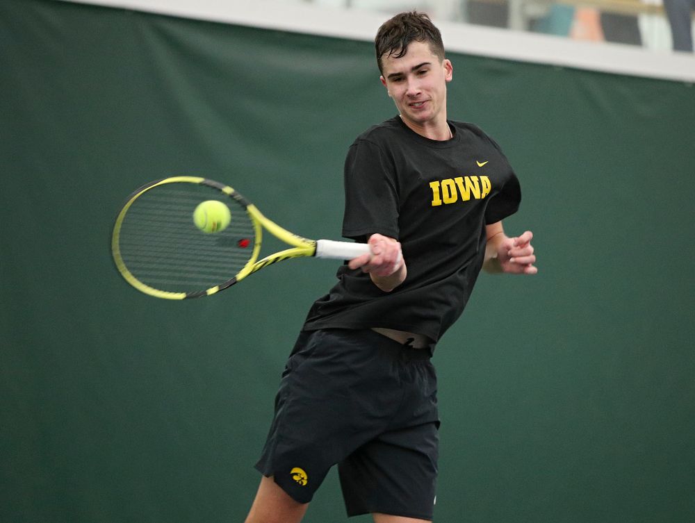 Iowa’s Matt Clegg hits a shot during his match against Marquette at the Hawkeye Tennis and Recreation Complex in Iowa City on Saturday, January 25, 2020. (Stephen Mally/hawkeyesports.com)