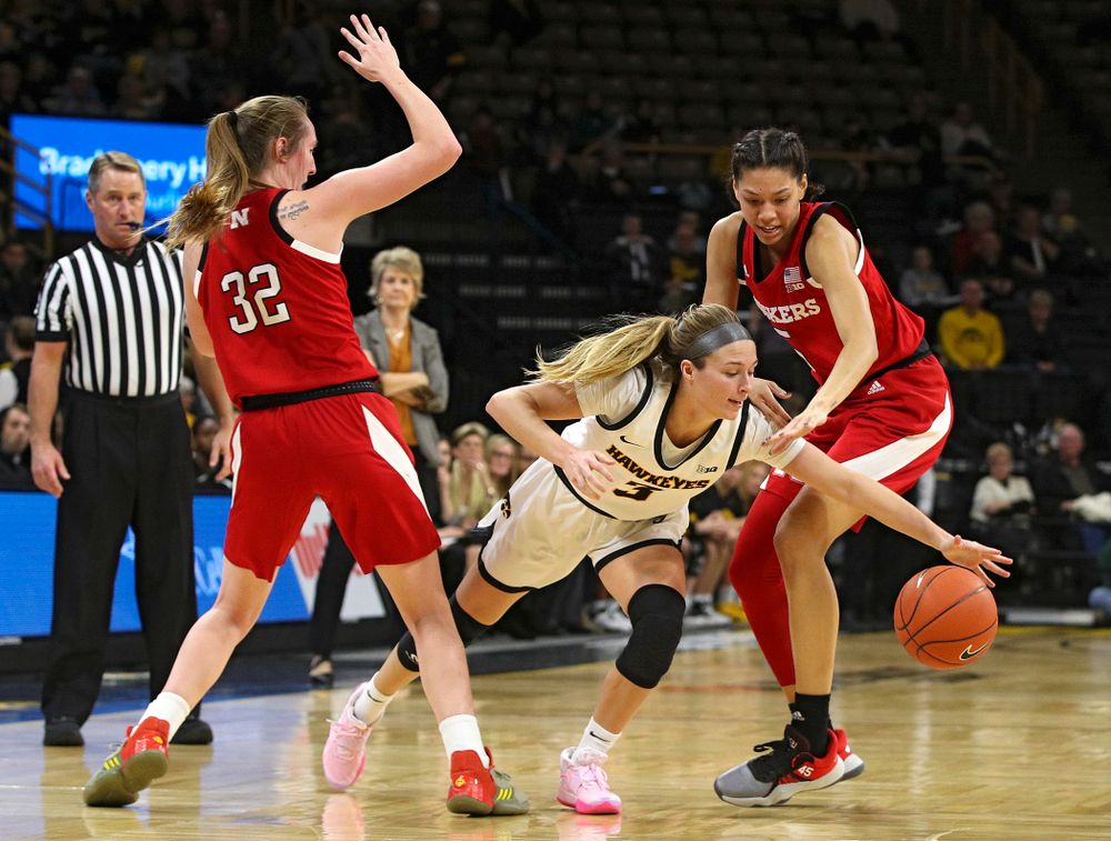 Iowa Hawkeyes guard Makenzie Meyer (3) splits two defenders during the second quarter of the game at Carver-Hawkeye Arena in Iowa City on Thursday, February 6, 2020. (Stephen Mally/hawkeyesports.com)