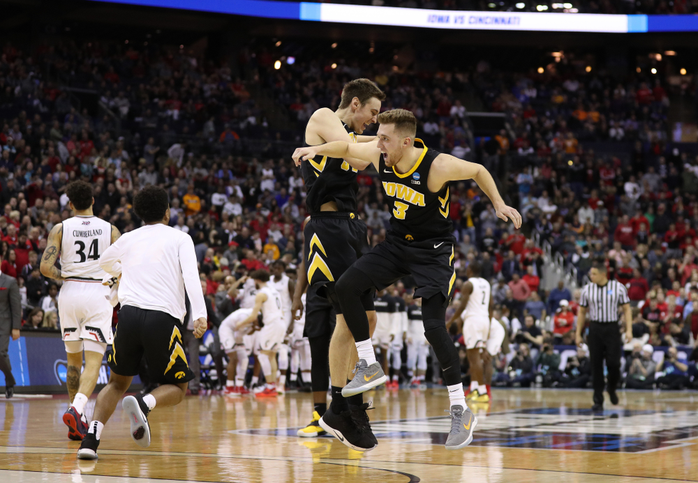 Iowa Hawkeyes guard Jordan Bohannon (3) and forward Nicholas Baer (51) against the Cincinnati Bearcats in the first round of the 2019 NCAA Men's Basketball Tournament Friday, March 22, 2019 at Nationwide Arena in Columbus, Ohio. (Brian Ray/hawkeyesports.com)