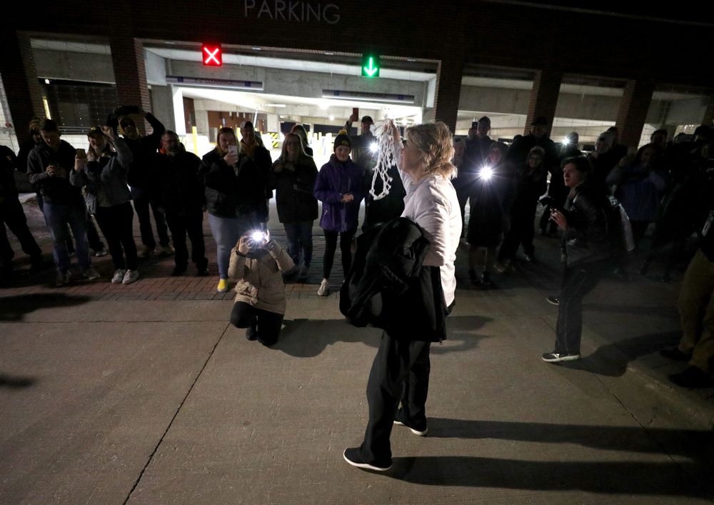 Iowa Hawkeyes head coach Lisa Bluder celebrates with fans as they arrive back in Coralville after defeating the Maryland Terrapins in the Big Ten Championship Game Sunday, March 10, 2019 in Indianapolis, Ind. (Brian Ray/hawkeyesports.com)
