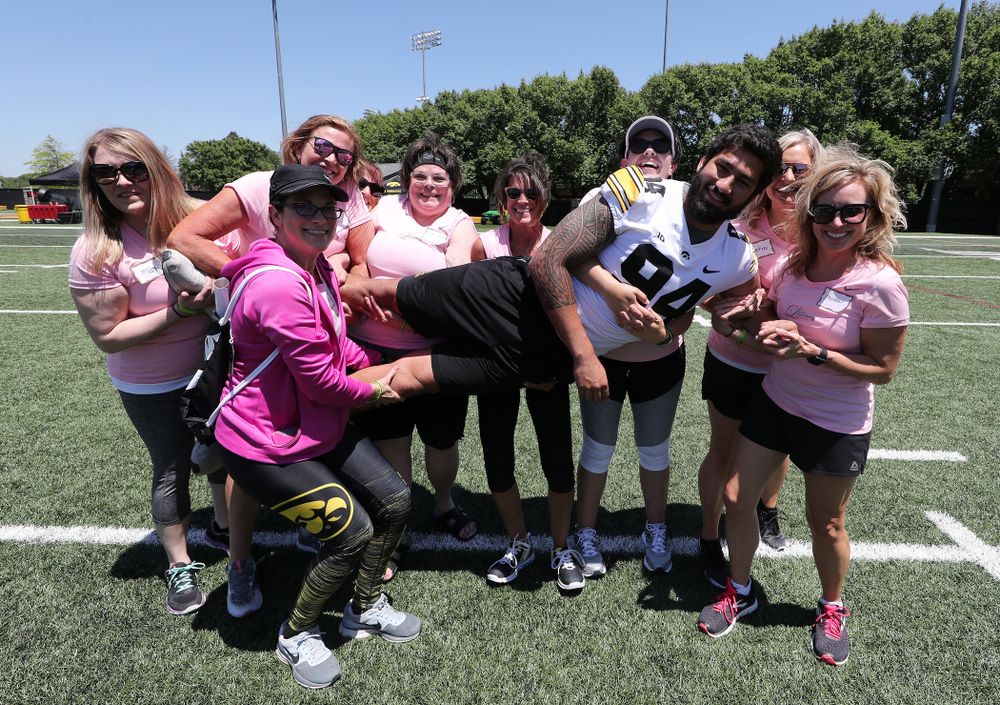 Iowa Hawkeyes defensive end A.J. Epenesa (94) is picked up by a group of women during the 2019 Iowa Ladies Football Academy Saturday, June 8, 2019 at the Hansen Football Performance Center. (Brian Ray/hawkeyesports.com)