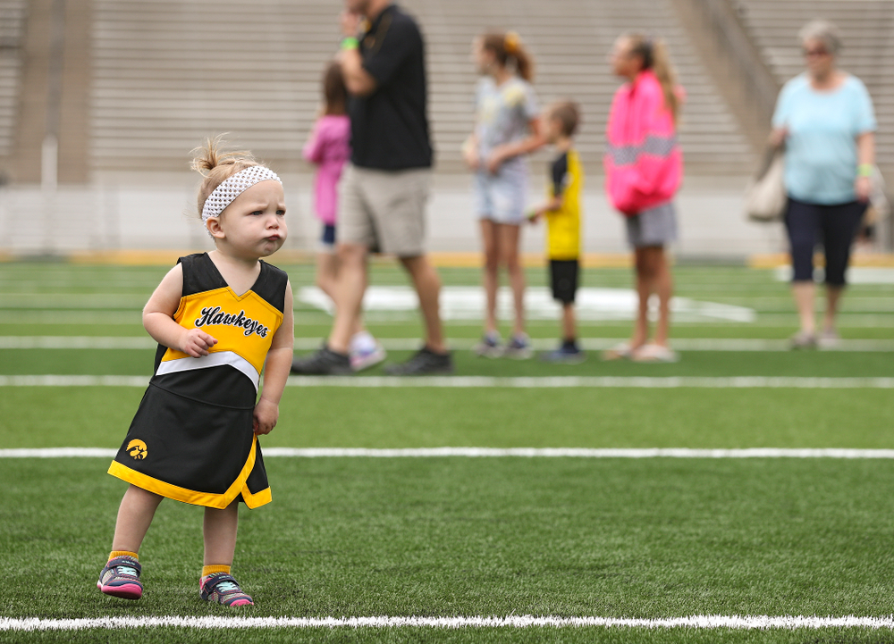 A young fan walks on the field as Junior Hawk Club members participate in the Swarm Experience during Kids Day at Kinnick Stadium in Iowa City on Saturday, Aug 10, 2019. (Stephen Mally/hawkeyesports.com)