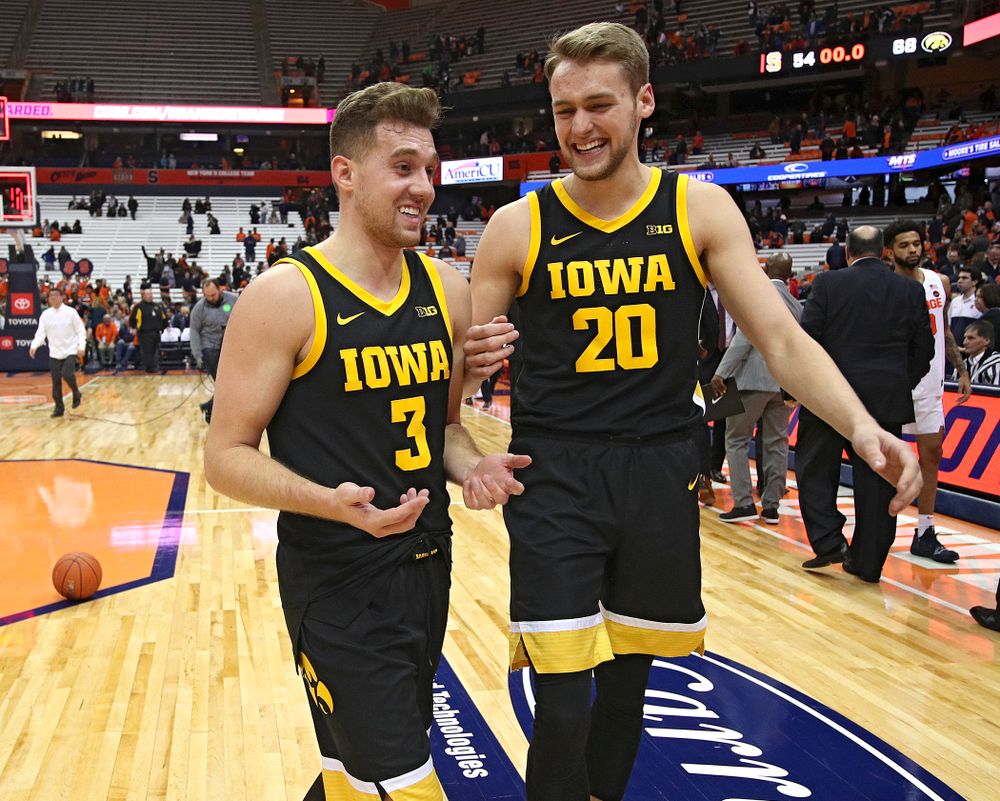 Iowa Hawkeyes guard Jordan Bohannon (3) and forward Riley Till (20) talk after winning their ACC/Big Ten Challenge game at the Carrier Dome in Syracuse, N.Y. on Tuesday, Dec 3, 2019. (Stephen Mally/hawkeyesports.com)