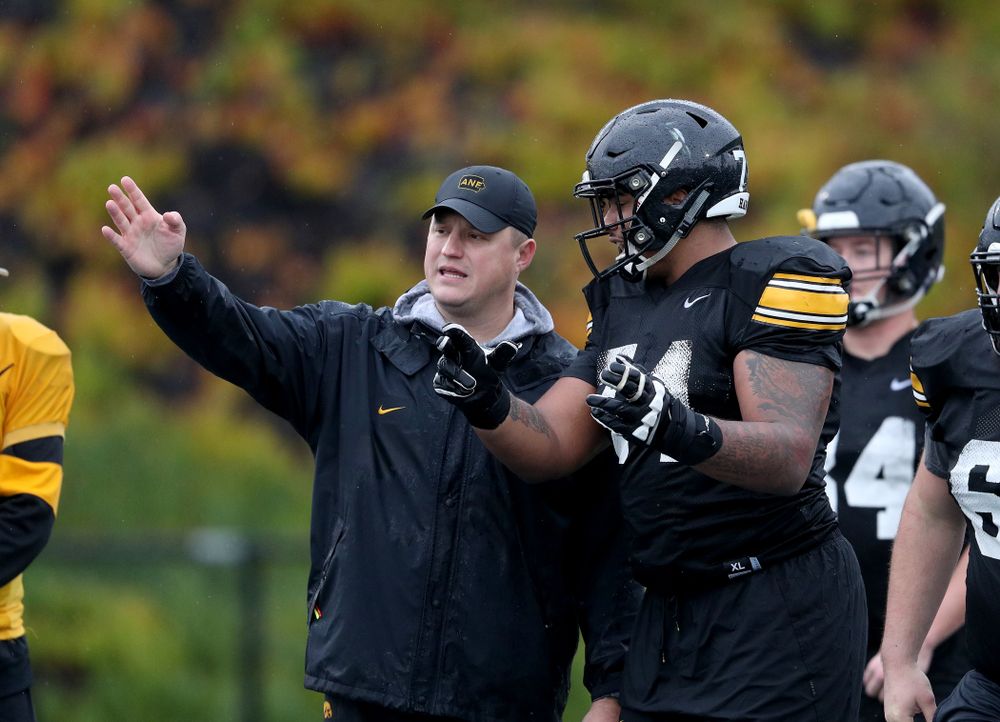 Iowa Hawkeyes offensive coordinator Brian Ferentz talks with offensive lineman Tristan Wirfs (74) during practice Monday, December 23, 2019 at Mesa College in San Diego. (Brian Ray/hawkeyesports.com)