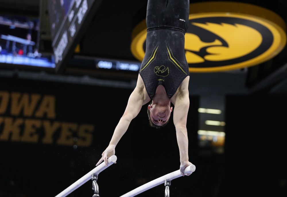 Iowa's Jake Brodarzon competes on the parallel bars against the Ohio State Buckeyes Saturday, March 16, 2019 at Carver-Hawkeye Arena. (Brian Ray/hawkeyesports.com)