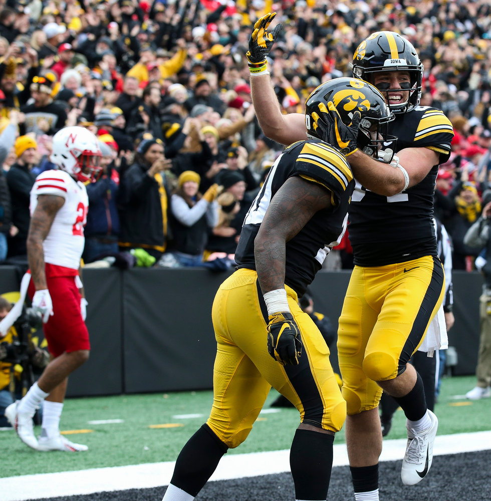 Iowa Hawkeyes wide receiver Nick Easley (84) and Iowa Hawkeyes running back Mekhi Sargent (10) celebrate after Sargent's touchdown run
