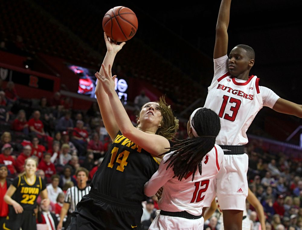 Iowa guard/forward McKenna Warnock (14) makes a basket while being fouled during the second quarter of their game at the Rutgers Athletic Center in Piscataway, N.J. on Sunday, March 1, 2020. (Stephen Mally/hawkeyesports.com)