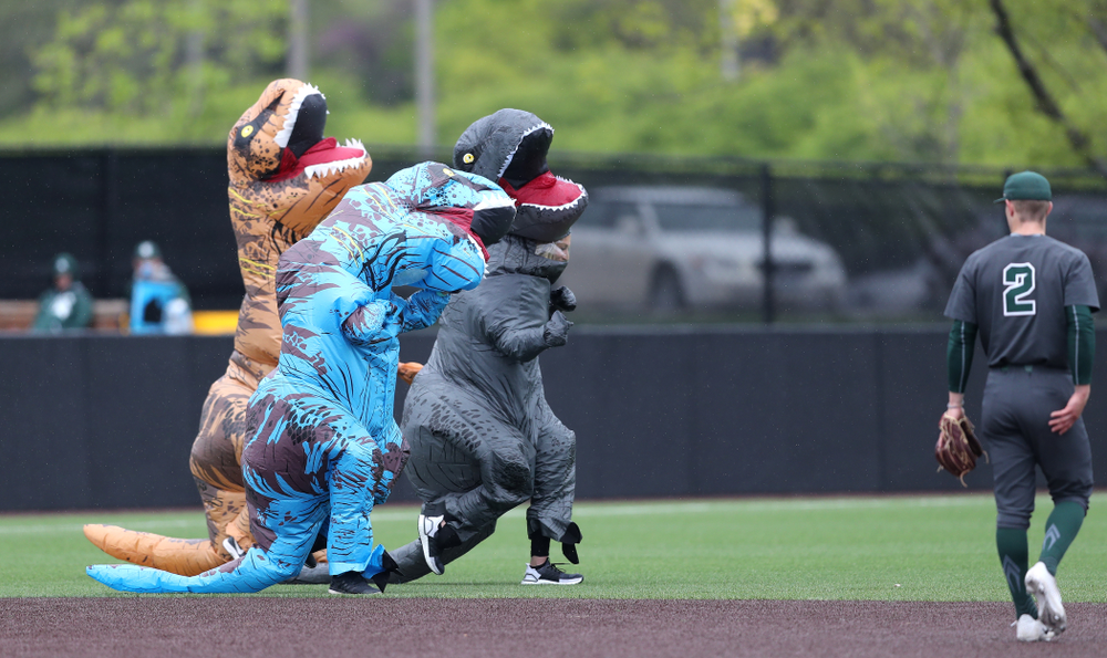 Rachel Heller, Susie Lund, and Emily run the dinosaur race during the Iowa Hawkeyes game against Michigan State Sunday, May 12, 2019 at Duane Banks Field. (Brian Ray/hawkeyesports.com)