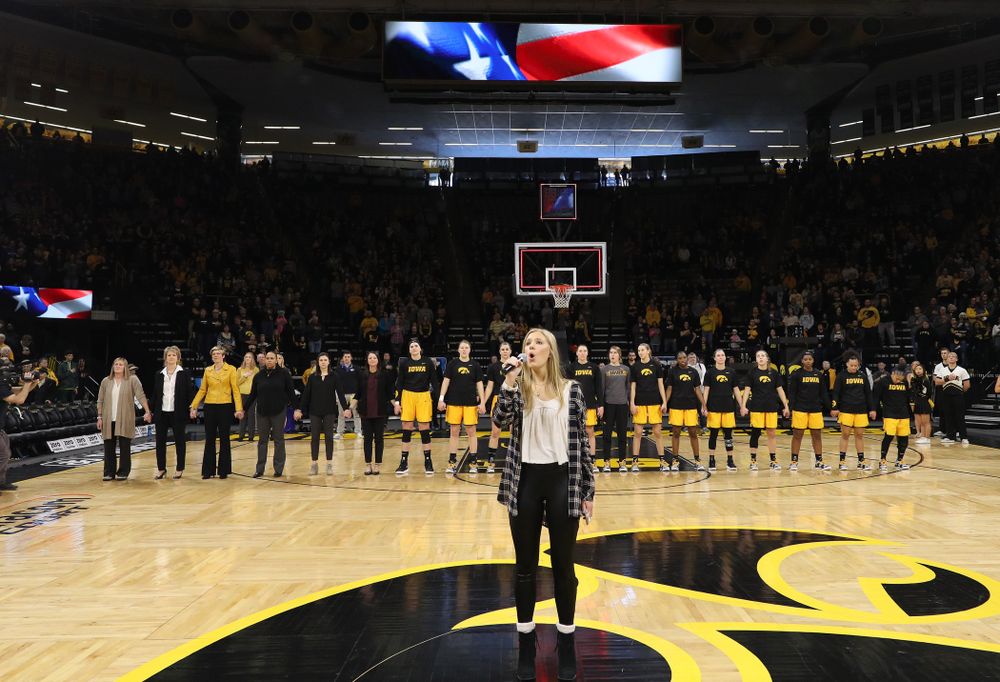 Iowa Hawkeyes head coach Lisa Bluder watches as her daughter Emma sings the National Anthem before the Iowa Hawkeyes game against the Northwestern Wildcats Sunday, March 3, 2019 at Carver-Hawkeye Arena. (Brian Ray/hawkeyesports.com)