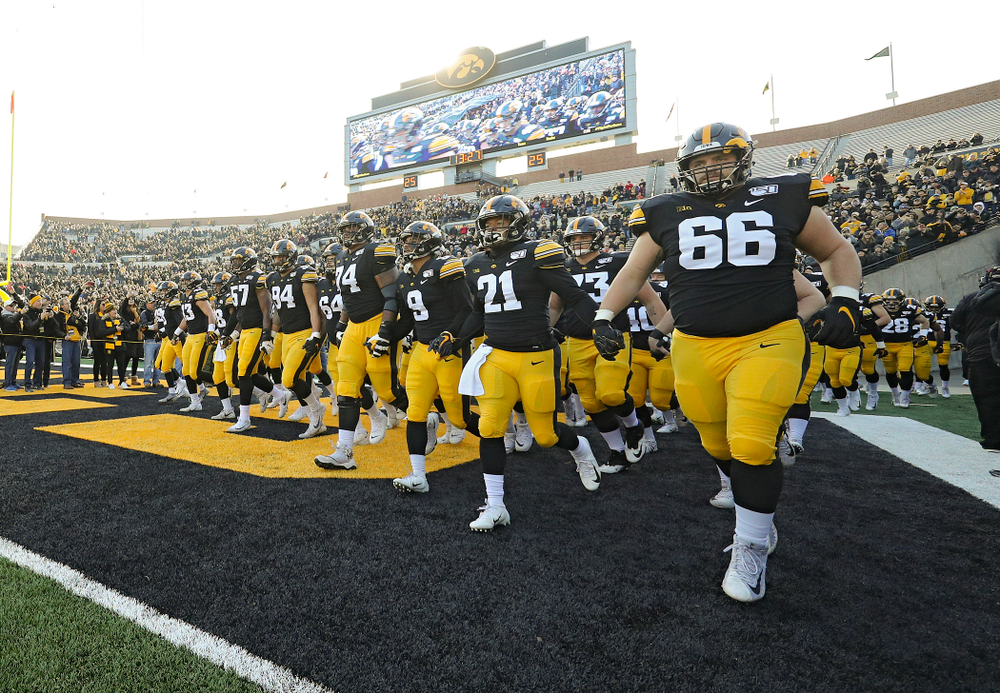 The Iowa Hawkeyes swarm as they take the field before their game at Kinnick Stadium in Iowa City on Saturday, Nov 23, 2019. (Stephen Mally/hawkeyesports.com)