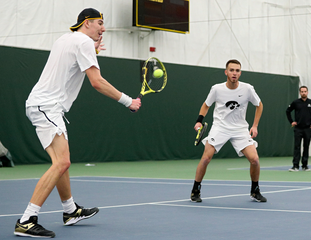 Iowa’s Nikita Snezhko (from left) returns a shot as Kareem Allaf looks on during their doubles match at the Hawkeye Tennis and Recreation Complex in Iowa City on Sunday, February 16, 2020. (Stephen Mally/hawkeyesports.com)