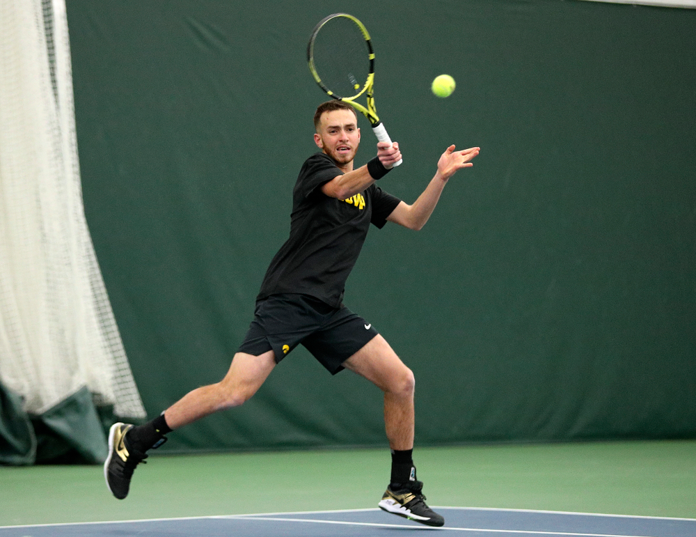 Iowa’s Kareem Allaf returns a shot during his doubles match at the Hawkeye Tennis and Recreation Complex in Iowa City on Friday, February 14, 2020. (Stephen Mally/hawkeyesports.com)