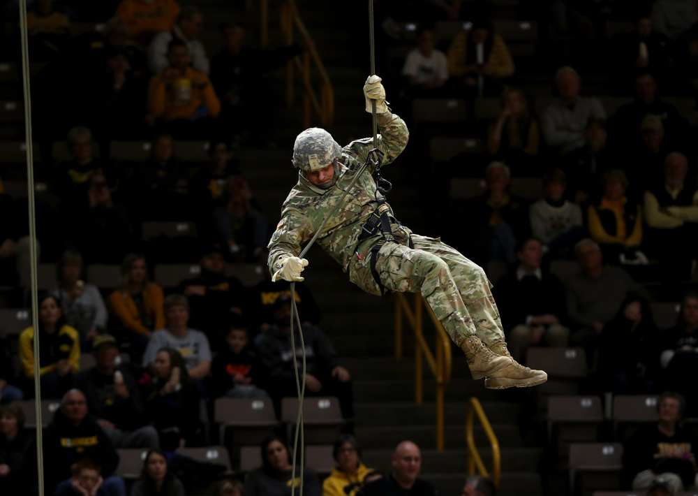 Members of the University of Iowa ROTC cadre repel down from the rafters before the Iowa Hawkeyes game against UW Green Bay Sunday, November 11, 2018 at Carver-Hawkeye Arena. (Brian Ray/hawkeyesports.com)