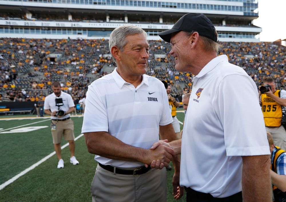Iowa Hawkeyes head coach Kirk Ferentz and Northern Iowa head coach Mark Farley shake hands before a game against Northern Iowa at Kinnick Stadium on September 15, 2018. (Tork Mason/hawkeyesports.com)