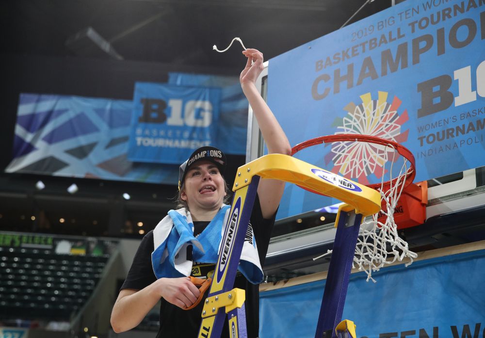 Iowa Hawkeyes forward Hannah Stewart (21) cuts down the net as they celebrate their victory over the Maryland Terrapins in the Big Ten Championship Game Sunday, March 10, 2019 at Bankers Life Fieldhouse in Indianapolis, Ind. (Brian Ray/hawkeyesports.com)